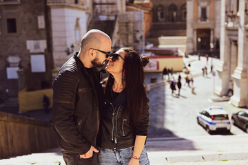  Portrait  of Happy  Tourists  couple   in love traveling at Rome, Italy,    Hugging   at Campidoglio Square.Concept of Italian travel. 