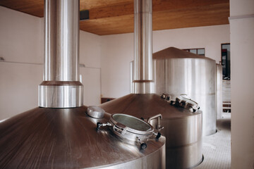 Brewery equipment. Brew manufacturing. Round cooper storage tanks for beer fermentation and maturation