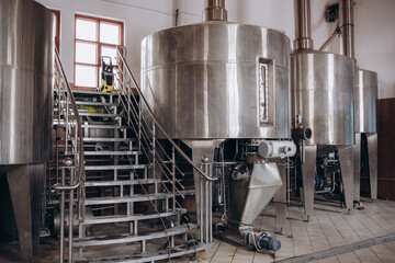 Modern Beer Factory. Rows of steel tanks for beer fermentation and maturation