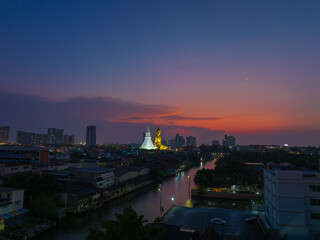 Fototapeta na wymiar aerial view amazing sky in twilight at golden big Buddha..beautiful red cloud over bangkok city..golden big Buddha Wat Paknam Phasi Charoen famous landmarks in Bangkok Thailand.