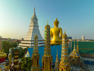 Naklejka premium .aerial view golden big Buddha Wat Paknam Phasi Charoen in sunset. .beautiful sunset reflection on a canal in front big buddha. .scenery sky in twilight background.the one famous landmarks