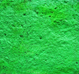 Green textured background.  Painted concrete wall texture.  Abstract artistic background. Rough retro surface. Vintage background for designers.