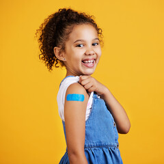 Happy, portrait and child with a plaster in a studio for a wound, sore or injury on her arm....