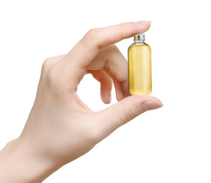 Woman's hand hold Bottle of essential oil isolated on white background