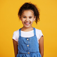 Studio, portrait and happy child with a smile on face isolated on a yellow background. Cute...