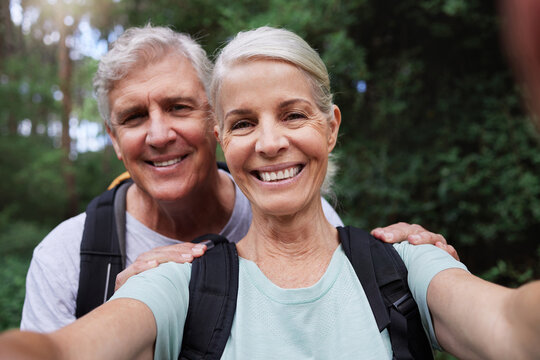 Selfie, Hiking And Portrait Of Senior Couple With Smile On Adventure In Forest, Woods And Mountain For Exercise. Fitness, Retirement And Happy Elderly Man And Woman Take Picture Trekking For Wellness