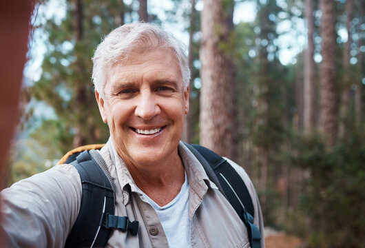 Selfie portrait, forest and senior man hiking, fitness and outdoor health with happy blog update for social media. Nature, travel and trekking of mature person in woods with profile picture post