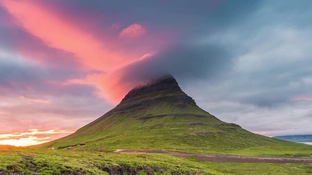 Landscape of sunset shining over Kirkjufell mountain and colorful pileus cloud in summer at Iceland
