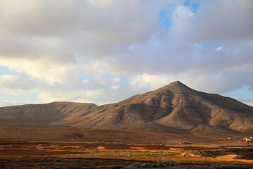 Panoramic view of arid climate in a desert land in Fuerteventura at the sunset.