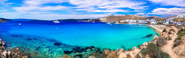 Greece summer holidays. Cyclades .Most famous and beautiful beaches of Mykonos island -Platis Gialos with crystal clear waters - obrazy, fototapety, plakaty