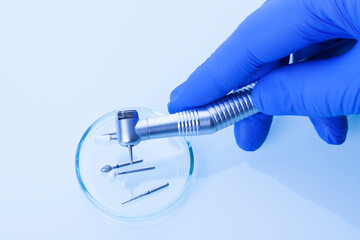 Dentist holding a dental tool in the hand