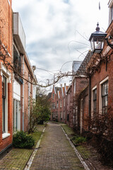 Fototapeta na wymiar Street with old houses in Haarlem, Netherlands
