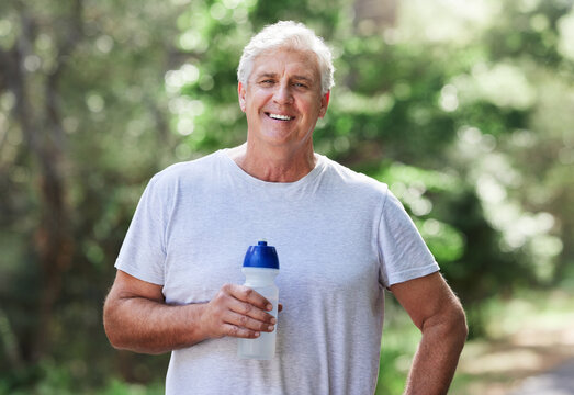 Man, exercise portrait and outdoor with water bottle for run, workout and training for fitness. Senior male happy for hydration, cardio health and wellness while running in nature and retirement