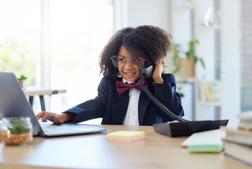 Young child, playing office and phone call with laptop for networking, contact or communication. Girl, smile and listening for deal, negotiation and reading website on computer at desk in workplace