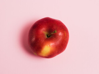 Delicious juicy apple on a pink background. Concept of earth day, zero waste and recycling