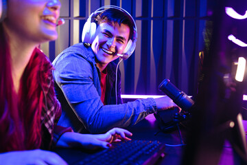 Male gamer playing against a female player in a video game contest
