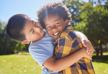 Happy, children or friends hugging in park together for fun, bonding or playing in sunny summer. Portrait, diversity or excited young boy best friends smiling or embracing on school holidays outside
