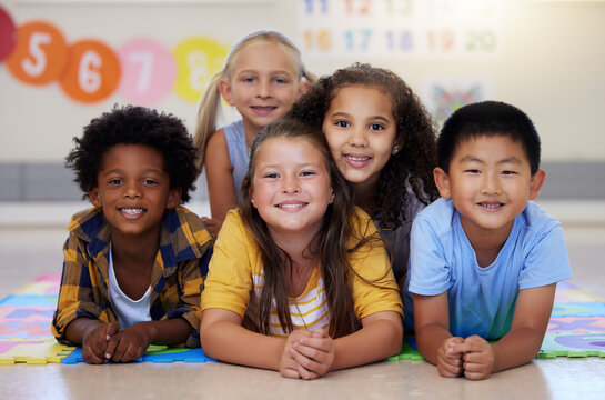 Education, portrait or happy children in classroom learning or smiling in preschool together with support. Kids development, diversity or students with growth mindset for knowledge in kindergarten