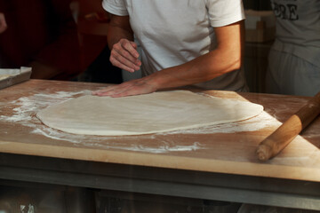 Obraz na płótnie Canvas Making pizza at the restaurant kitchen