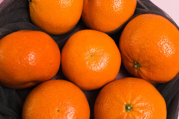 Tangerines in a net for vegetables and fruits. Concept of earth day, zero waste and recycling.