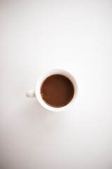 White cup of coffee on white background