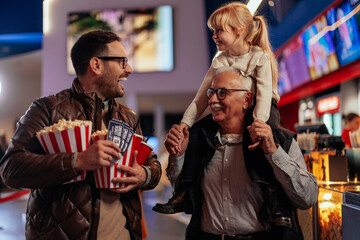 Excited family in movie theater.