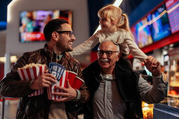 Elderly man with family in cinema.