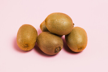 Fototapeta premium Kiwi without packaging on a pink background. Concept of earth day, zero waste and recycling.