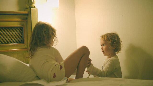 Two little girls making a phone call from the hotel. Room service or telecom concepts