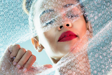 Beauty, bubble wrap and makeup with breakthrough with woman for package, creative and cosmetics....