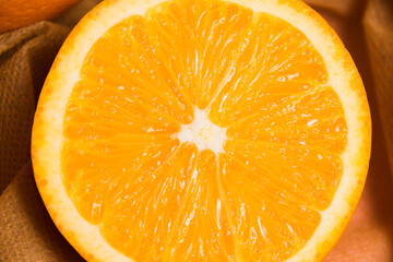 Juicy orange in a reusable bag for fruits and vegetables. Concept of earth day, zero waste and recycling.