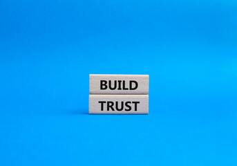 Build trust symbol. Wooden blocks with words Build trust. Beautiful blue background. Business and Build trust concept. Copy space.