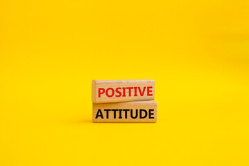 Positive attitude symbol. Concept words Positive attitude on wooden blocks. Beautiful yellow background. Business and Positive attitude concept. Copy space.