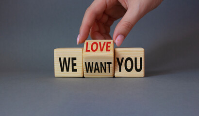 We love and want You symbol. Businessman Hand turns cubes and changes word We want you to We love you. Beautiful grey background. Business and We love and want You concept. Copy space