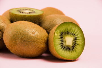 Juicy kiwi on a pink background. Delicious fruit on a bright background.