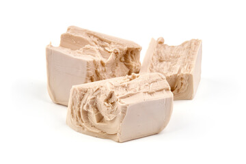 Fresh yeast cube, isolated on white background.