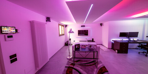 Modern room with bight led strips light. Tv, monitor and sofa
