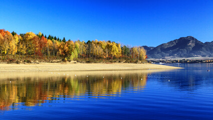 Reflection of colorful autumn trees on water of lake Liptovska Mara in Slovakia