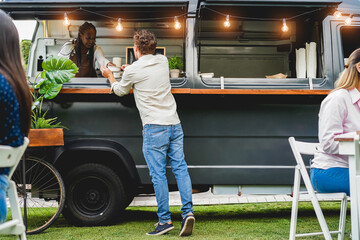 African senior woman working inside food truck - Focus on customer head - Smal business concept
