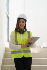 Asian Engineer working and quality check at construction site. Asian foreman construction standing at construction office