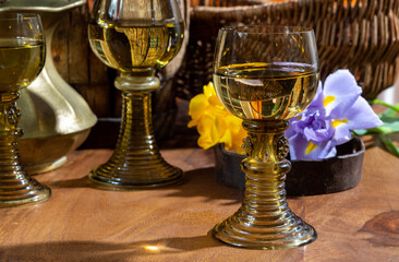 Antique German glassware, old Dutch style rummer or roemer glasses with white wine and flowers