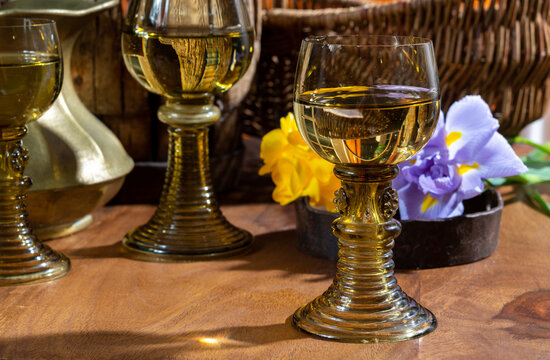 Antique German glassware, old Dutch style rummer or roemer glasses with white wine and flowers