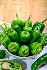 Fresh green mild padron pepper pementos, ready for grill or to be fried with olive oil, traditional snack in Galicia, Spain