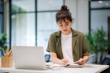 Young asian business woman or student working online on computer laptop.