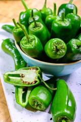 Fresh green mild padron pepper pementos, ready for grill or to be fried with olive oil, traditional snack in Galicia, Spain