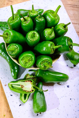 Fresh green mild padron pepper pementos, ready for grill or to be fried with olive oil, traditional snack in Galicia, Spain
