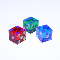 Three transparent dices in essential and primary colors on a light white surface and background.