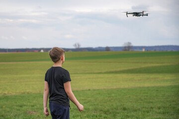 A frightened boy got stressed when he saw a quadcopter in the field.