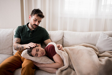 Wife feeling sick, while her husband is cuddling her.