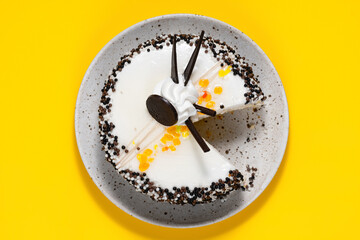 Delicious cake onon plate. Lunch at work. Copy space. Top view. Yellow background